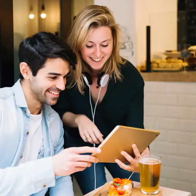 Happy small business owners reviewing online growth and leads from a digital marketing agency in India